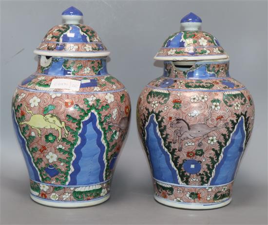 A pair of Chinese porcelain wucai jars and covers, late 19th/early 20th century height 36cm (a.f.)